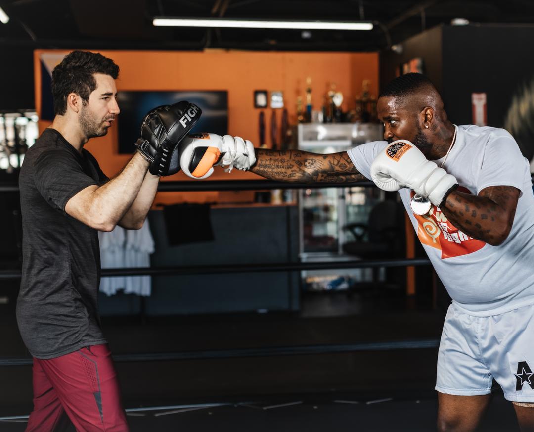 Coach holding mitts during a training session